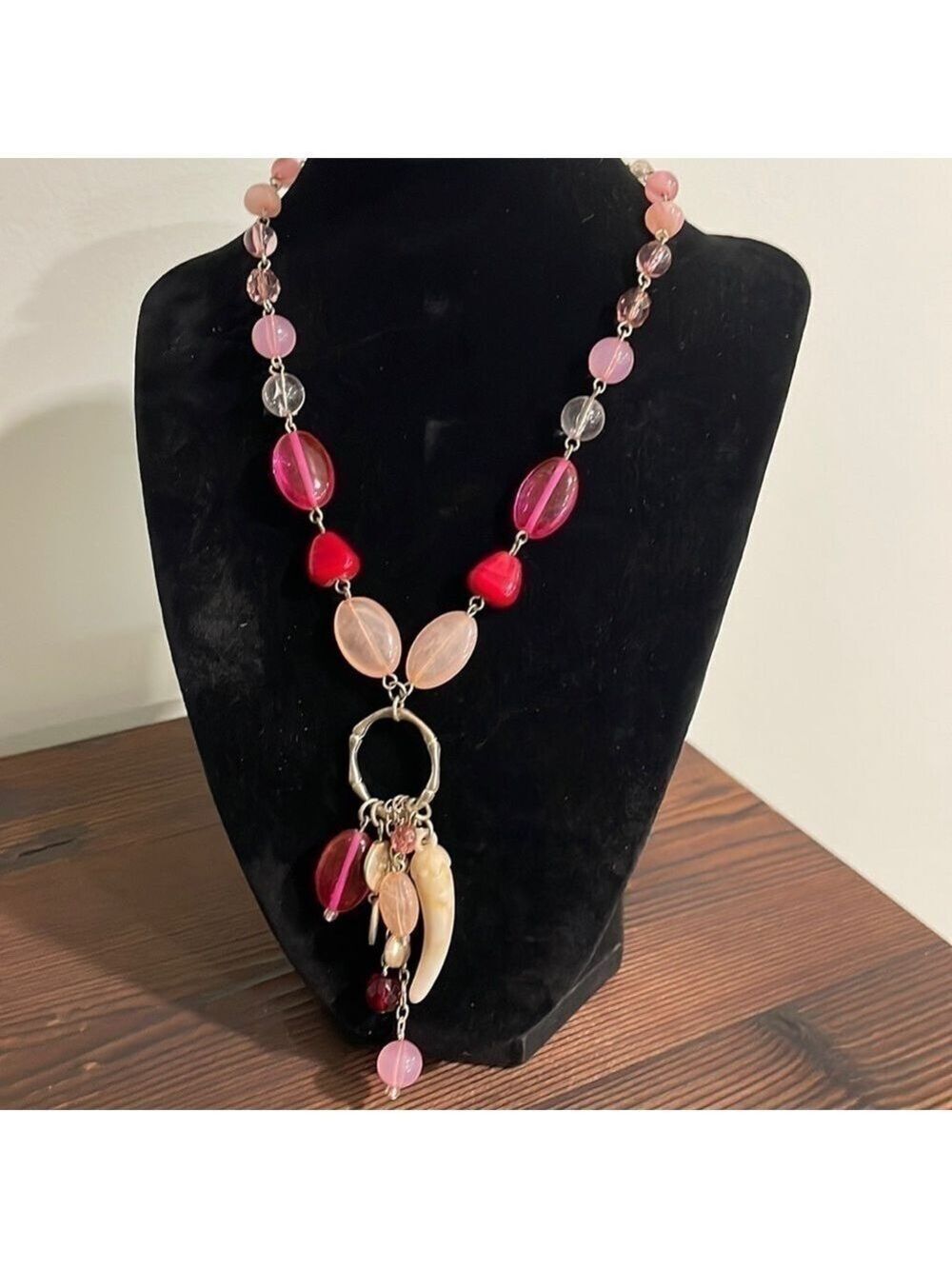Pink beaded charm necklace with stone horn of wealth and silver tone accents